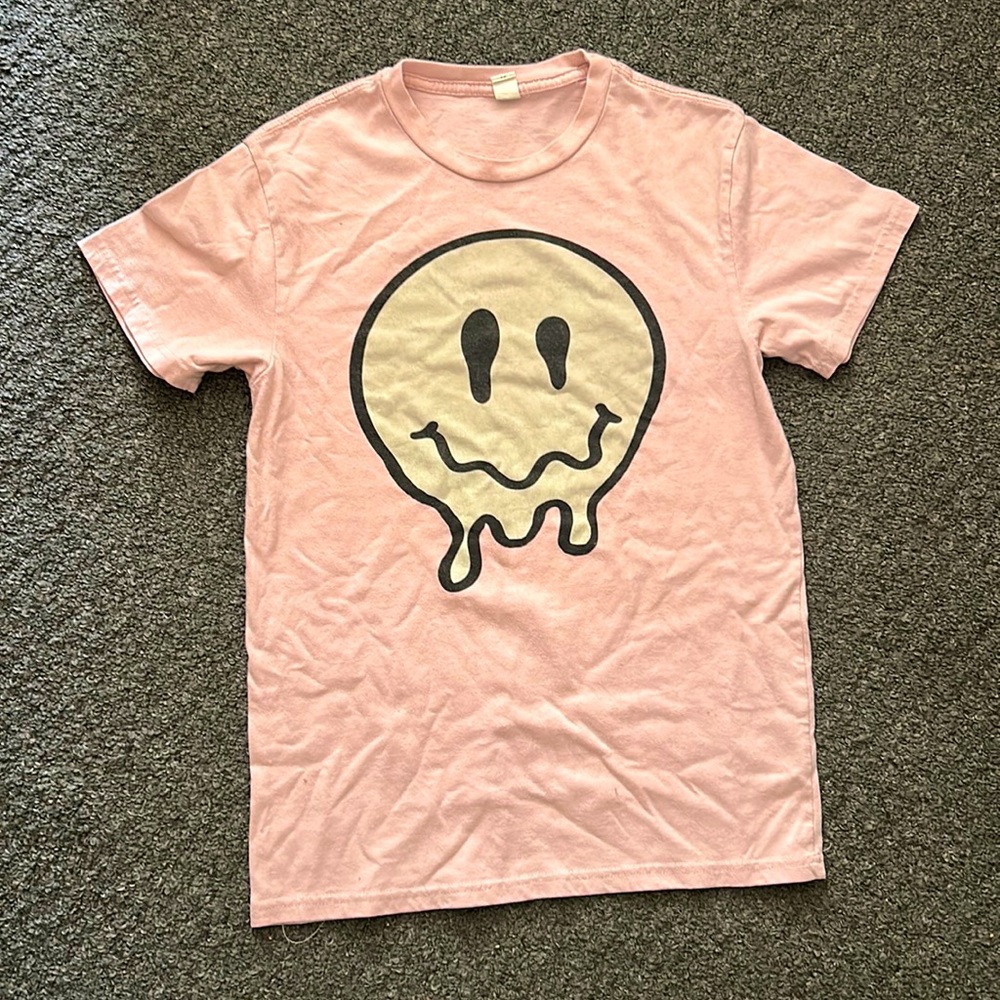 It’s a pink smiley face drip shirt from 5 below